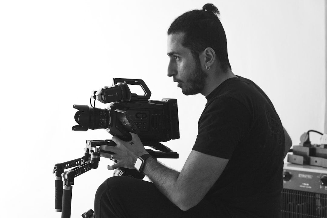 Camera operator adjusting a broadcast camera on set